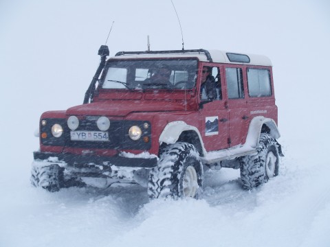 Skuli and Hannes in the trusted flame red Land Rover Defender