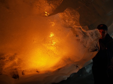 Holding a torch behind a clump of ice. 