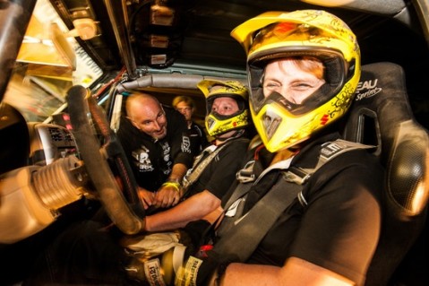 Michael Podlogar prepping the codriver. Jutta Kleinschmidt smiling about the new Suzuki helmets.