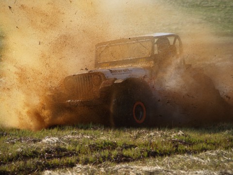 Haukur in the mud driving his Willys through a similar track as the modified trucks go.