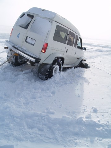 This Chevy van has a tire fall into a small creek and breaks a locking hub. After being winched out he limps back on his own.