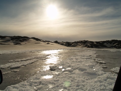 The scenery is beautiful with the glacier and partly cloudy sky in the back with small rivers and creeks coming from the spring melting.