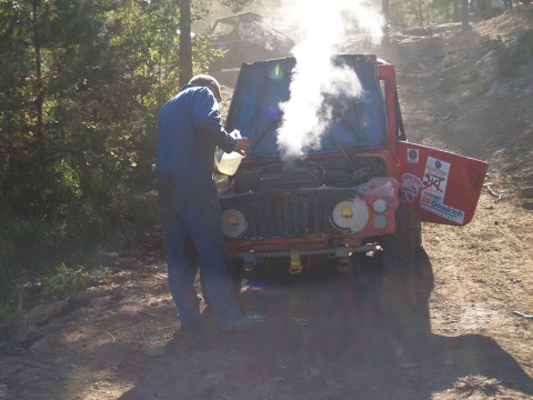 Sven Arne Knudsen in his small red Suzuki LJ80 having some heat problems. 