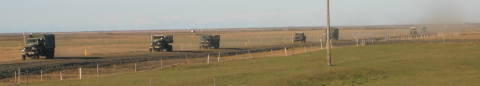 Old Army Trucks on Country Road